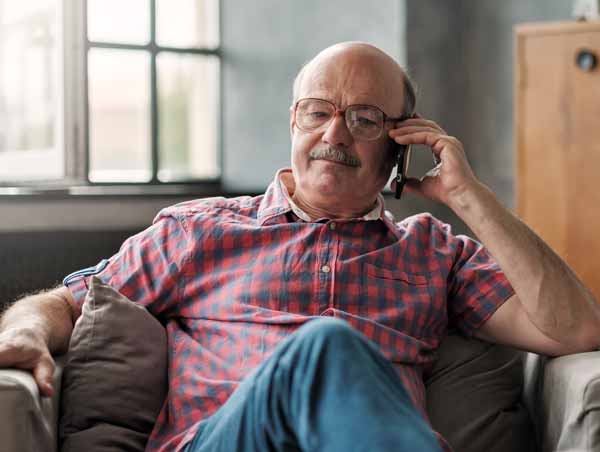 Photo of a customer on the phone; on hold.